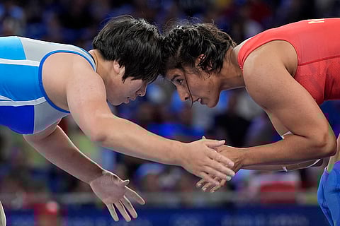 Nisha Dahiya and Sol Gum Pak compete during their women's freestyle 68kg wrestling quarterfinal